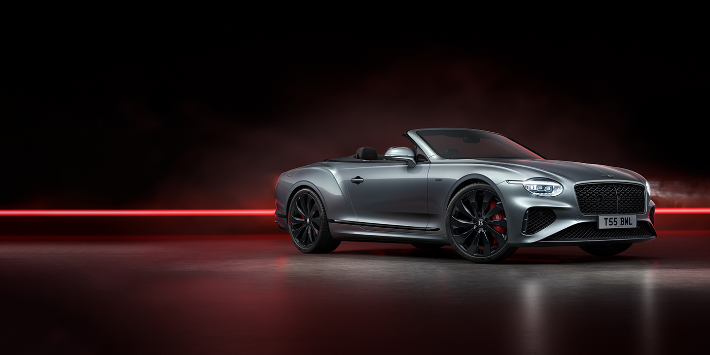 Bentley Paris Seine Bentley Continental GTC Black Edition convertible front three quarters in Hallmark silver against a dark grey and red background