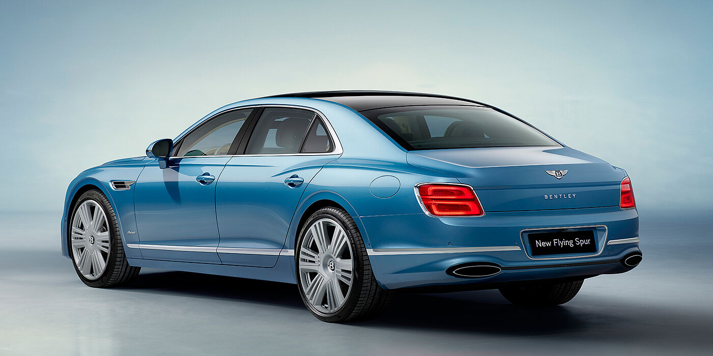 Bentley Paris Seine New Bentley Flying Spur Azure sedan rear view in Light windsor blue by Mulliner paint with 22 inch Azure wheels and chrome exterior details