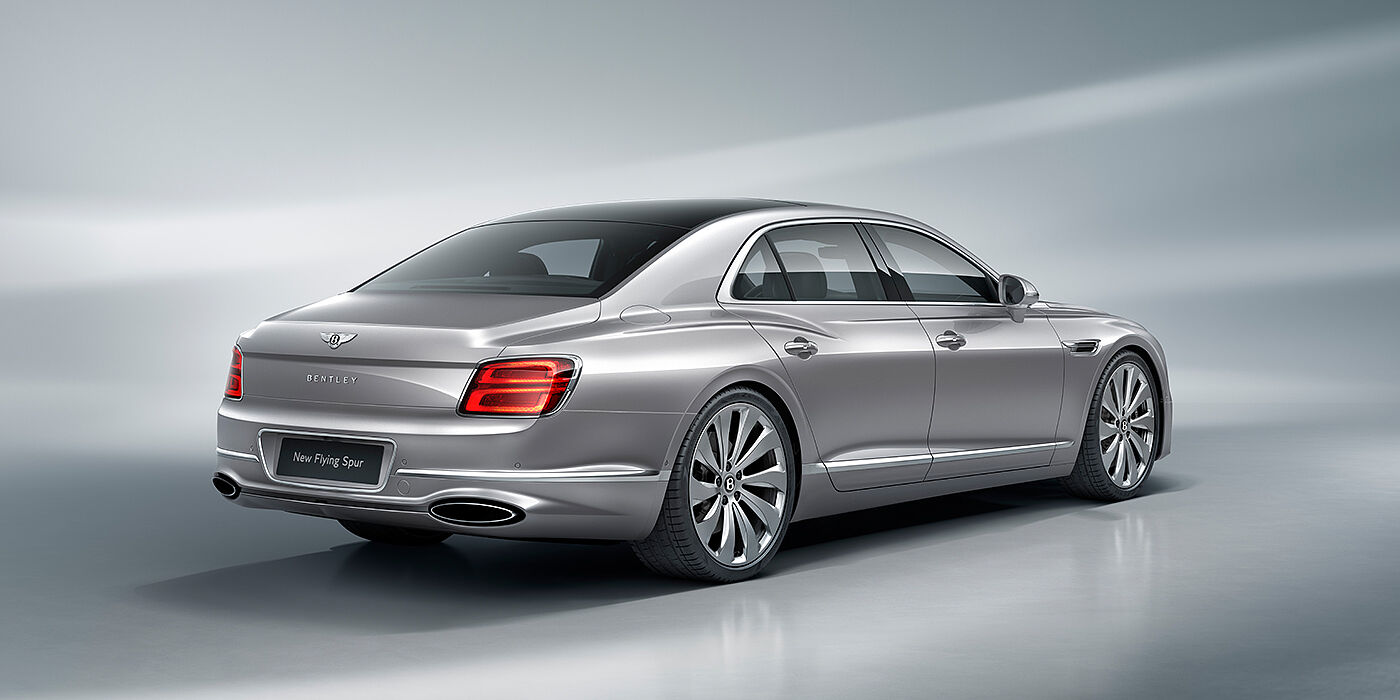 Bentley Paris Seine New Bentley Flying Spur sedan rear view in Silverlake paint with ten spoke wheels and chrome matrix grille