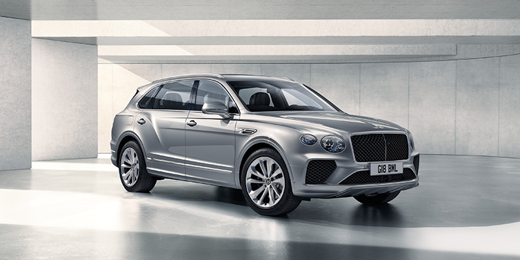 Bentley Paris Seine Bentley Bentayga Extended Wheelbase SUV front three quarter in Moonbeam paint with a grey background