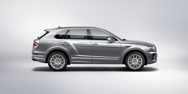 Bentley Paris Seine Bentley Bentayga SUV side profile in Moonbeam silver paint against white background featuring 21 inch 5 spoke wheels