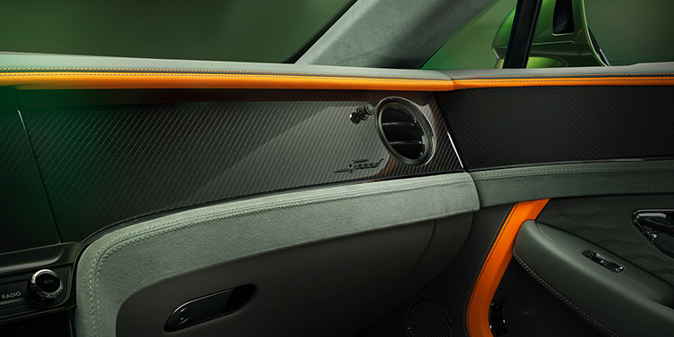 Bentley Paris Seine Bentley Continental GT Speed coupe front interior dash detail with high gloss carbon fibre veneer surrounded by Mandarin by Mulliner and Gravity Grey hides