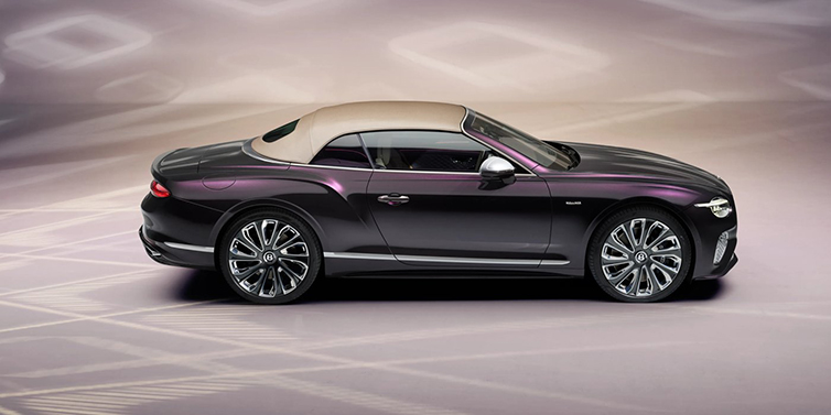 Bentley Paris Seine Bentley Continental GTC Mulliner convertible in profile with hood up, in Tanzanite Purple paint and 22 inch Mulliner painted and polished wheels