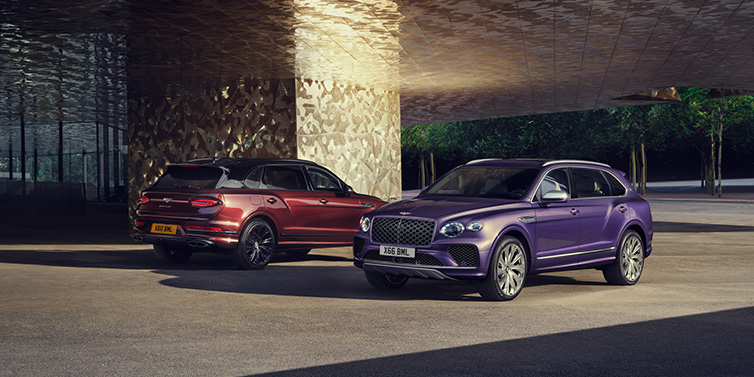 Bentley Paris Seine A duo of Bentley Bentayga Extended Wheelbase Mulliner SUVs parked in a city environment, with Tanzanite Purple and Cricket Ball red exterior paint