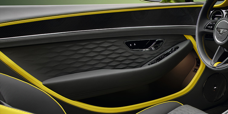 Bentley Paris Seine Bentley Continental GTC Speed convertible interior door details featuring Gravity Grey and Cyber Yellow by Mulliner hides and high gloss carbon fibre veneer