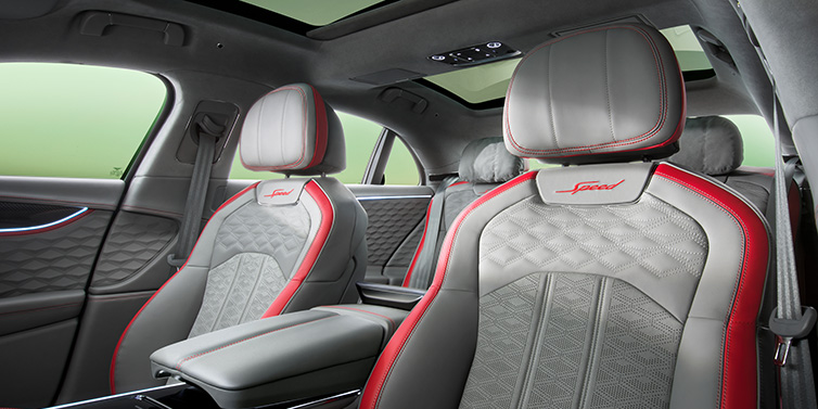 Bentley Paris Seine Bentley Flying Spur Speed sedan interior showing front and rear seats in Hotspur red and Gravity Grey hides, with Speed seat emblems