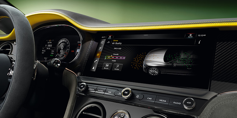 Bentley Paris Seine Bentley Continental GTC Speed convertible front interior centre console with MMI screen showing Air Quality visualisation surrounded by Cyber Yellow by Mulliner and Gravity Grey hides and high gloss carbon fibre veneer